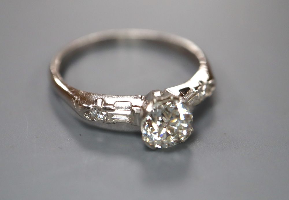 A modern white metal (stamped iridium and plat) and single stone diamond ring